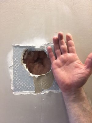Mr. Greg Duckworth showing the size of the hole by holding up his hand for comparison