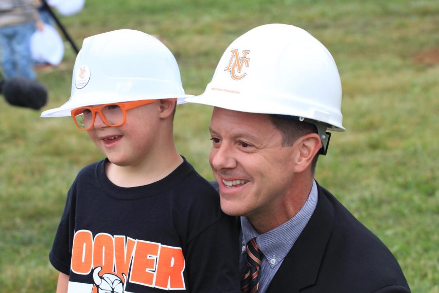 Northwood Principal Mr. Matthew Donaldson takes a photo with an NCCS student at the site of the new PK-2 building on Charlotte. 