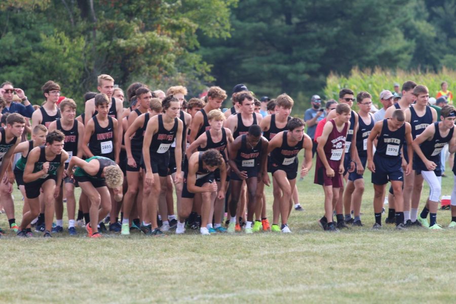 Junior Jacob Craig [second from bottom left] prepares to run a cross country race Sept. 3. Craig balances mental and physical fitness in his life.