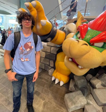 Rory, wearing his funny Donkey Kong t-shirt, stands in the clutches of King Bowser who rules over Nintendo New York.