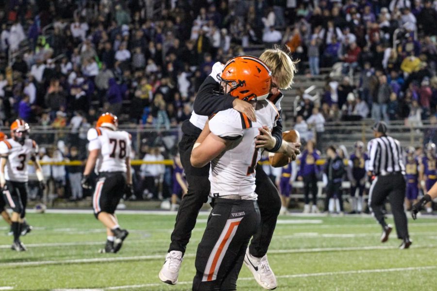 Senior Luke Roach [running back] runs to his brother, sophomore Bryce Roach [defensive end] after the 14-7 Viking victory over the Polar Bears.