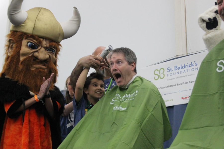 North Canton Assistant Superintendent David Pilati has his head shaved during the St. Baldrick’s event at the North Canton Racquet Club on March 12.  Photography: Campbell Hollis