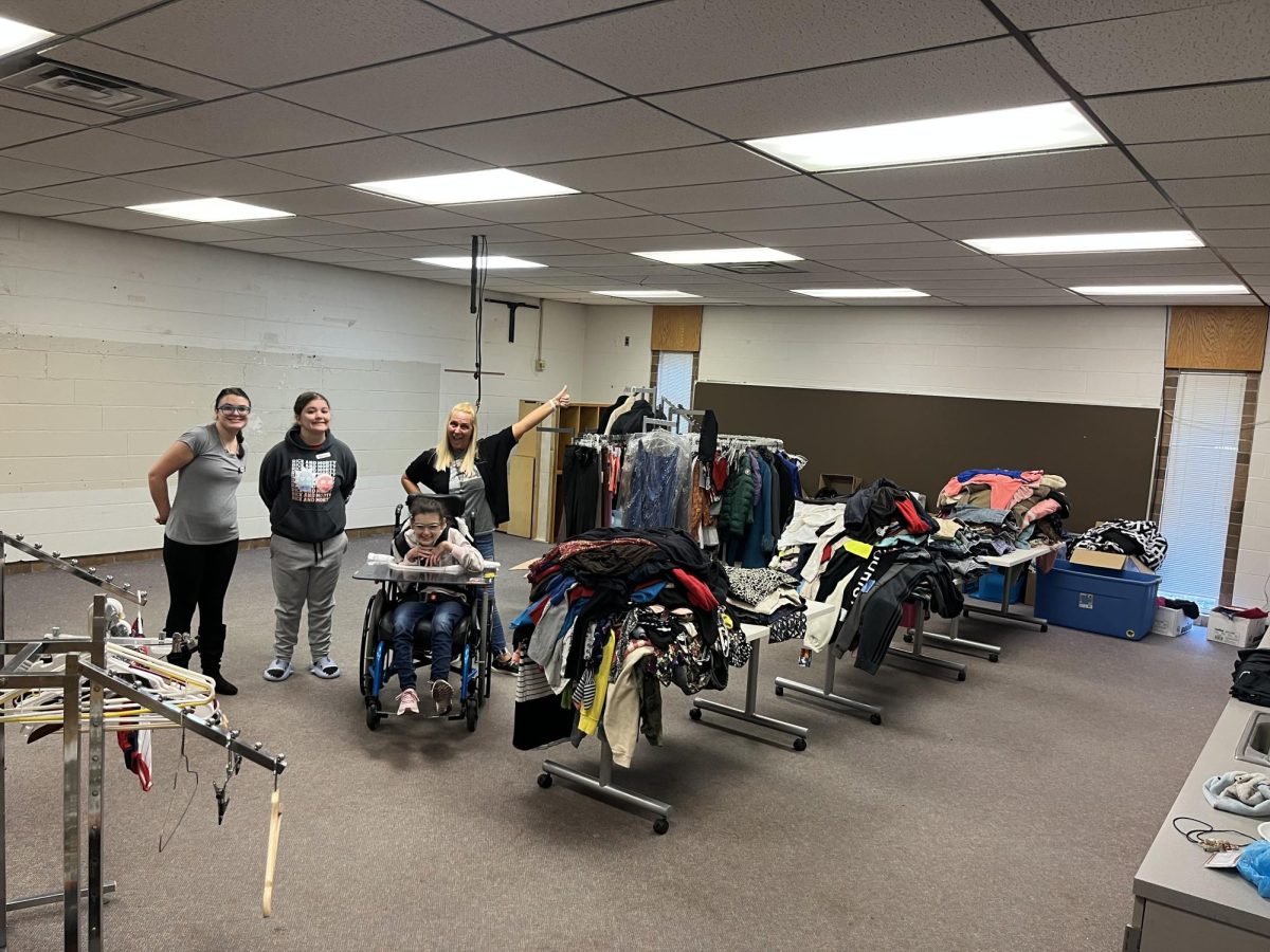 Hoover senior Raegan Russell and juniors Madison  Zemelka and Miah McClure work with Hoover staff member Mrs. Julie Carroll in 
setting up the North Canton Closet. The students are in Mrs. Lindsay Talkingtons  class. 
