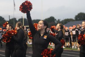 Junior Emma Chung waves up to the crowd during football game against Akron North Sept. 6.