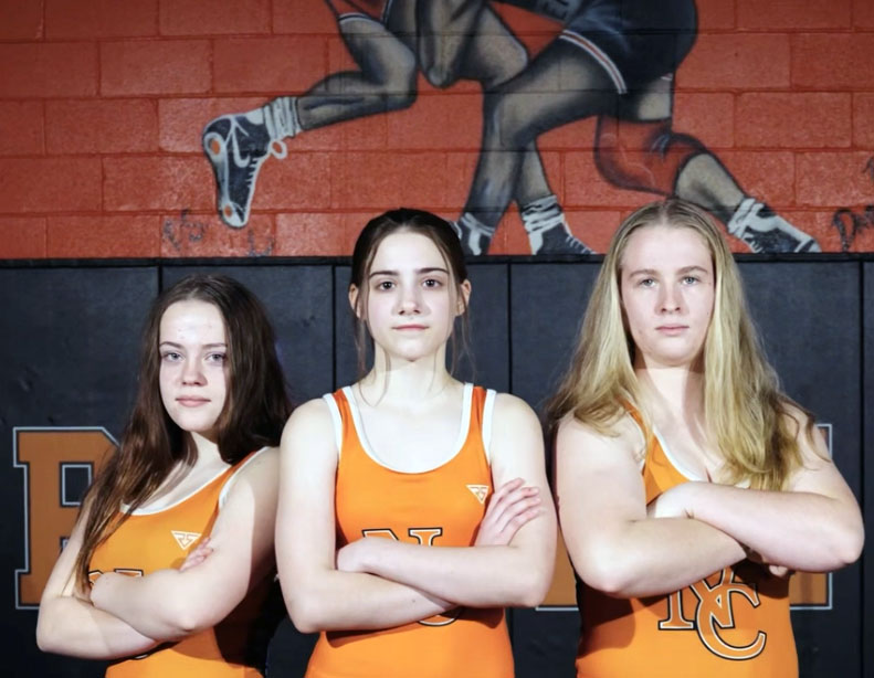 The girls wrestling poses for a picture.