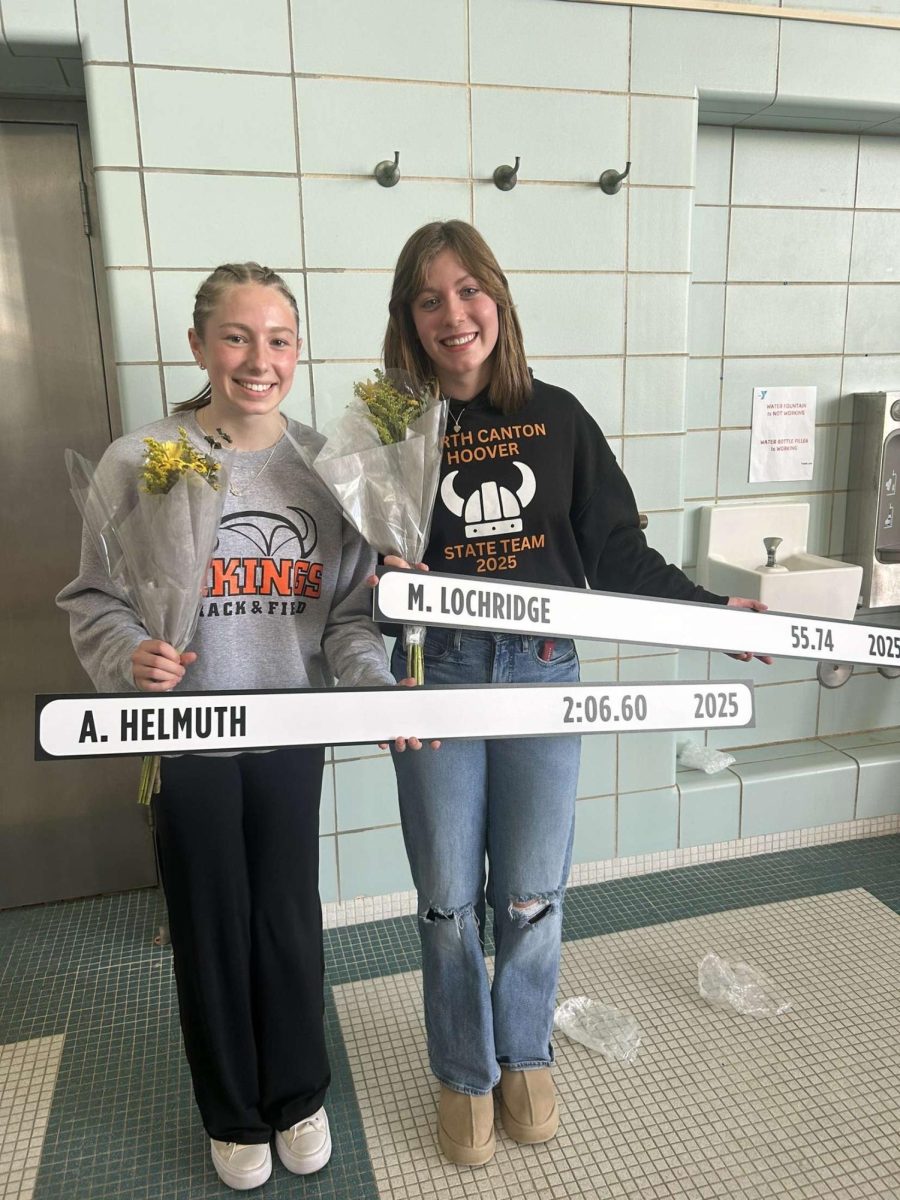 Juniors Anna Helmuth and Marie Lochridge celebrate putting their new record on the record board