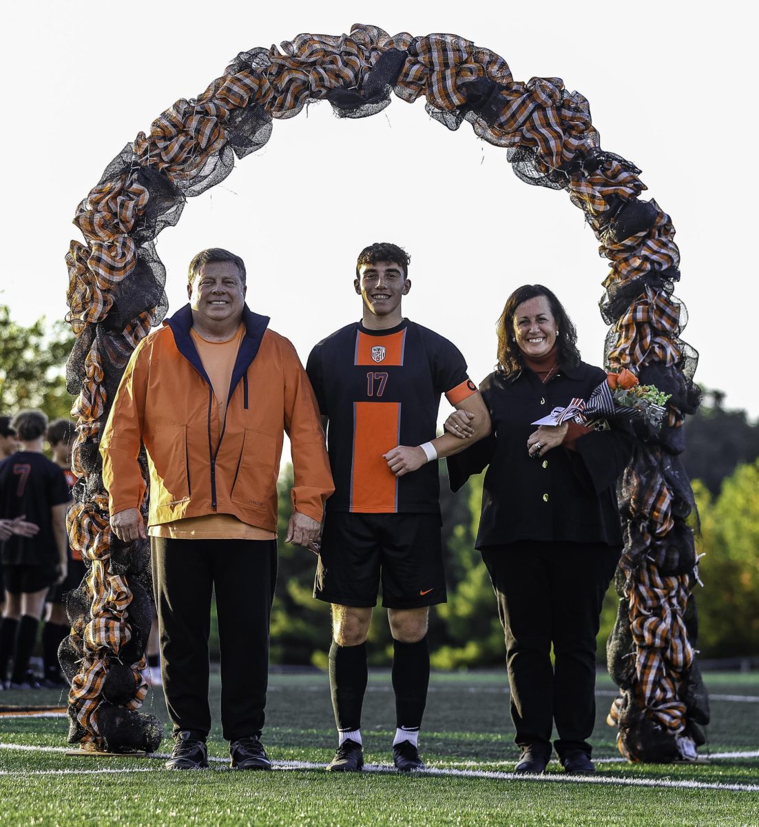 Senior varsity soccer player David Wadley poses with his parents during senior night Sept. 23. Hoover defeated McKinley 7-0.