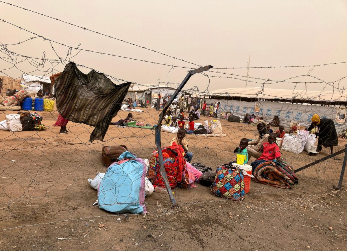 Refugees from Sudan wait behind the border crossing into South Sudan to continue their journey. (EvaMaria Krafczyk/dpa/TNS)