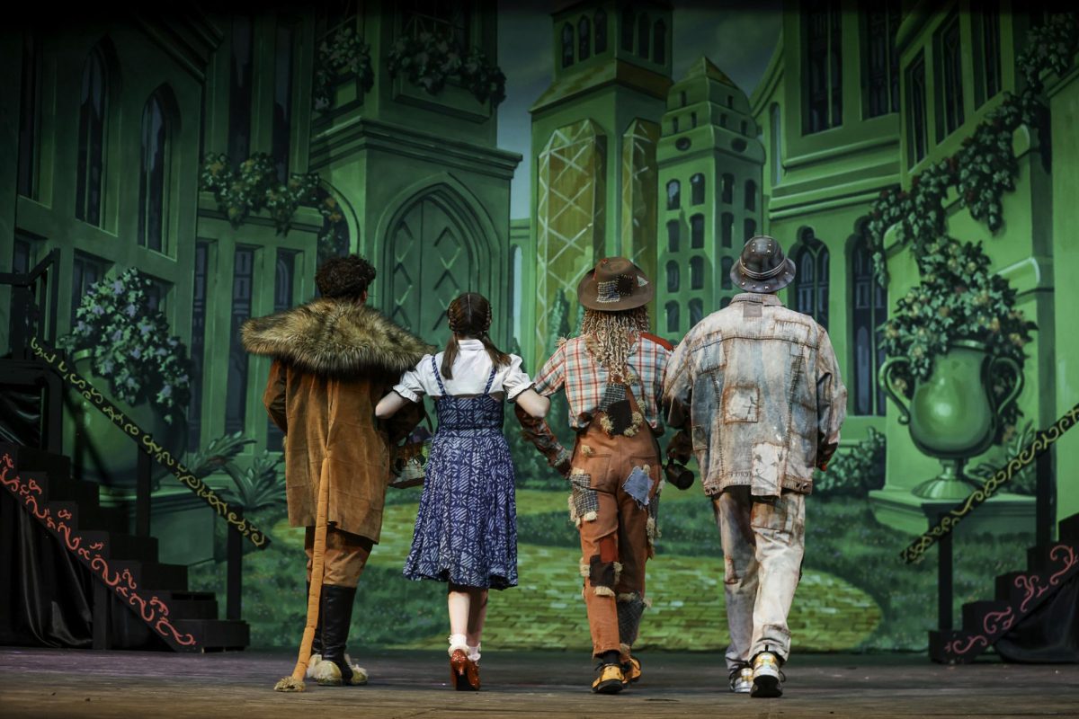 [from left] Freshman Austin Weaver, senior Carys Eynon, senior Andy Reynolds, and junior Nolan Pellegrino journey on the Yellow Brick Road towards the Emerald City.